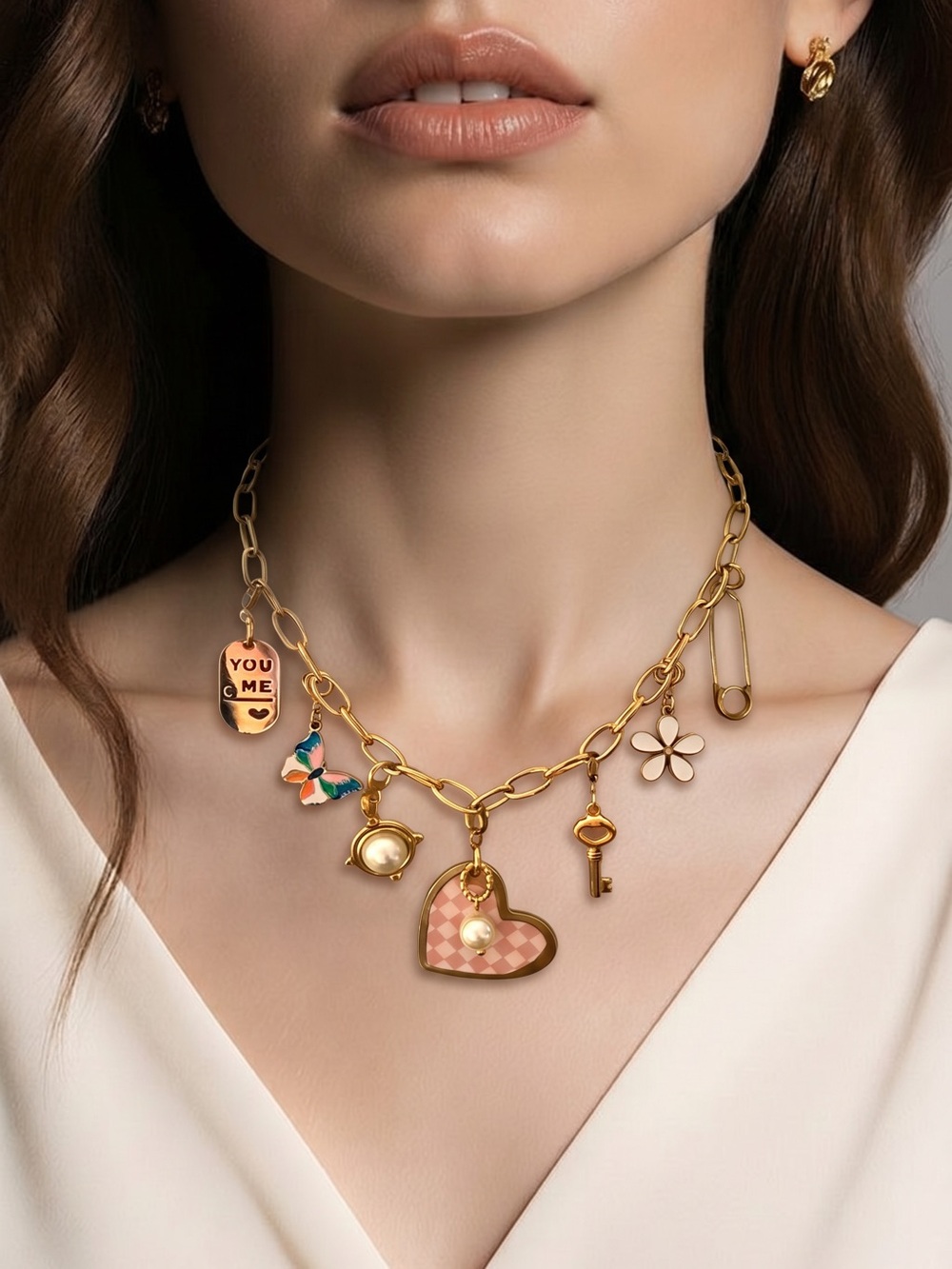 Plunder gold paperclip chain necklace features a variety of charms